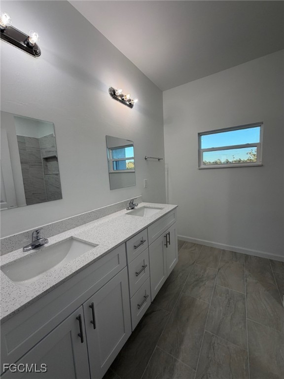 3307 10th Street Southwest Lehigh Acres, FL 33976 - Photo 10 of 13 a spacious bathroom with a double vanity sink and a mirror
