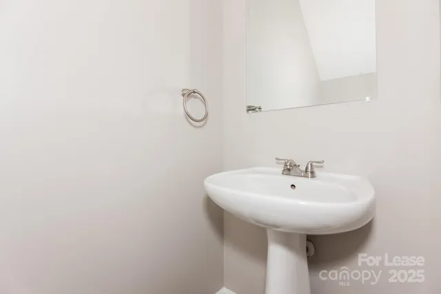 a bathroom with a sink and mirror