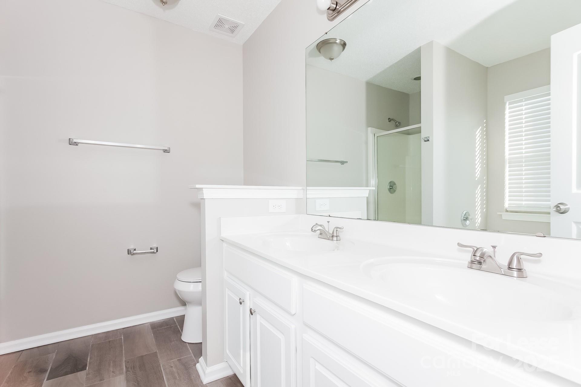 5537 Lemley Road Northwest Concord, NC 28027 - Photo 8 of 17 a bathroom with a sink a toilet and a mirror