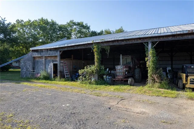 a view of a house with a yard and pathway