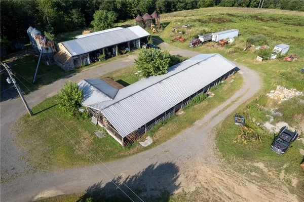 an aerial view of a house with yard swimming pool and outdoor seating