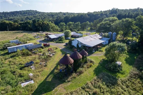 an aerial view of a house with swimming pool and a yard