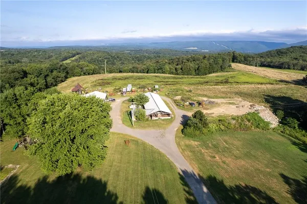 an aerial view of a house with swimming pool and a yard