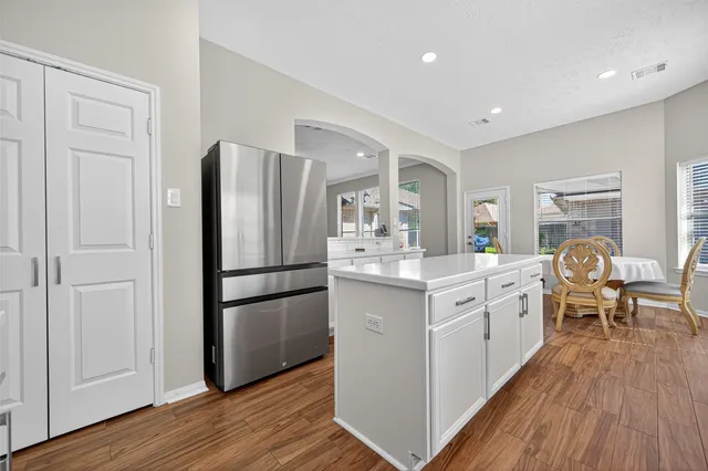 a kitchen with white cabinets and white appliances