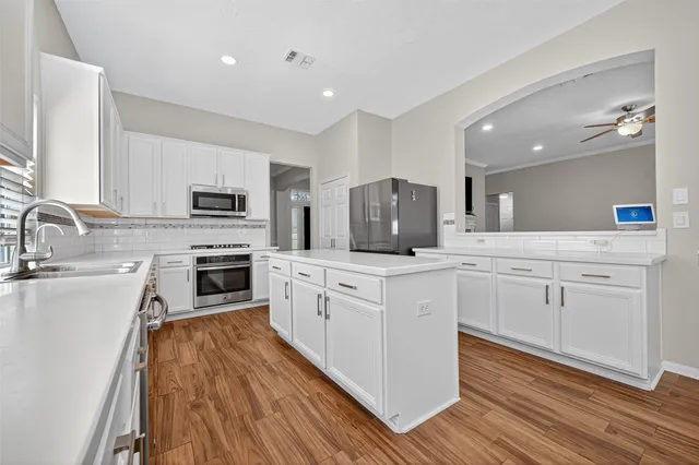a bedroom with furniture and a wooden floor