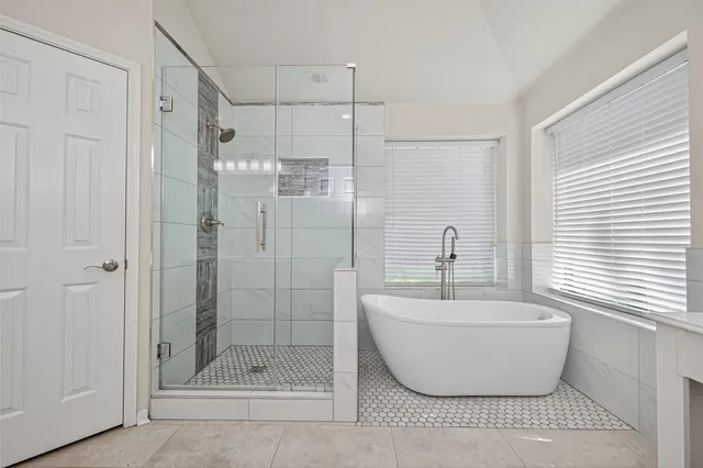 a bathroom with a shower sink and mirror
