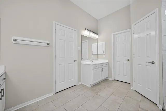 a bathroom with a double vanity sink mirror and shower