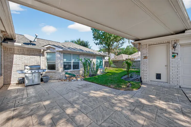 a view of a house with a yard and wooden fence