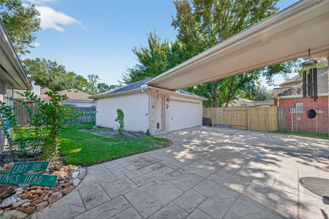a front view of a house with a yard and potted plants