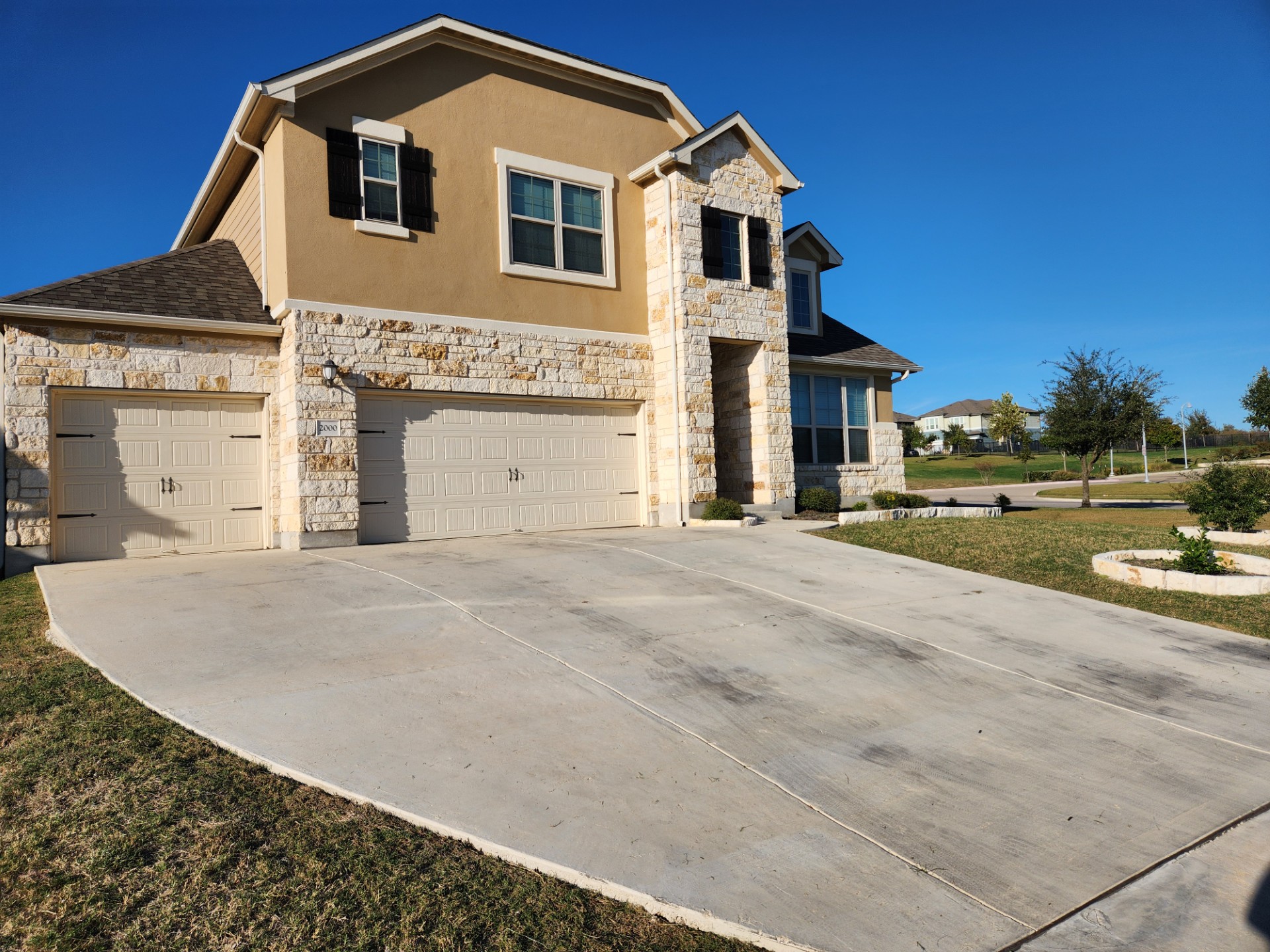 2000 Chamberlin Trail Georgetown, TX 78626 - Photo 3 of 3 View of front of house with stone siding, concrete driveway, stucco siding, and an attached garage