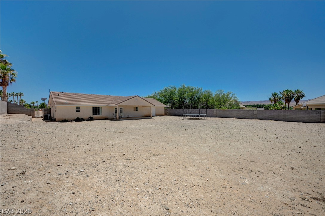 1272 Liston Avenue Logandale, NV 89021 - Photo 45 of 61 A spacious desert backyard offers vast potential for outdoor living and recreation.