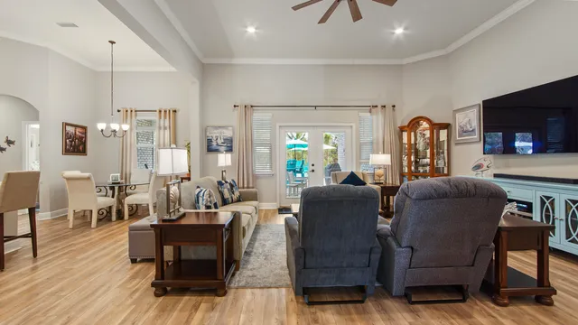 a living room with furniture kitchen and a large window