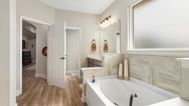 a bedroom with a large bed and a window