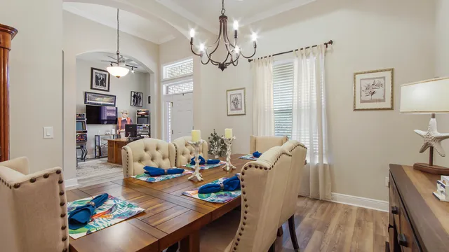 a view of a dining room with furniture wooden floor and a chandelier