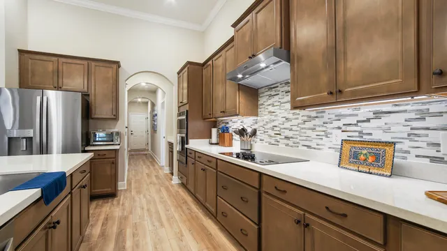 a kitchen with cabinets and a wooden floor