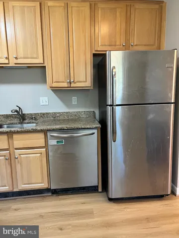 a white refrigerator freezer sitting inside of a kitchen