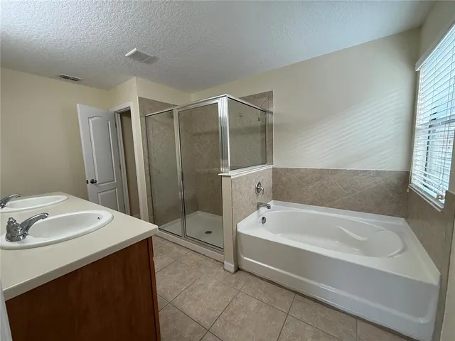 a bathroom with a tub sink and a mirror
