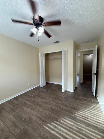 a view of an empty room and wooden floor