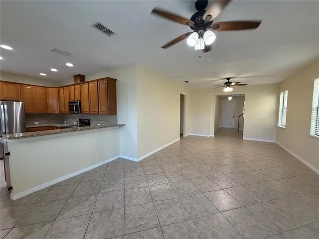 a view of a kitchen with a sink and a refrigerator