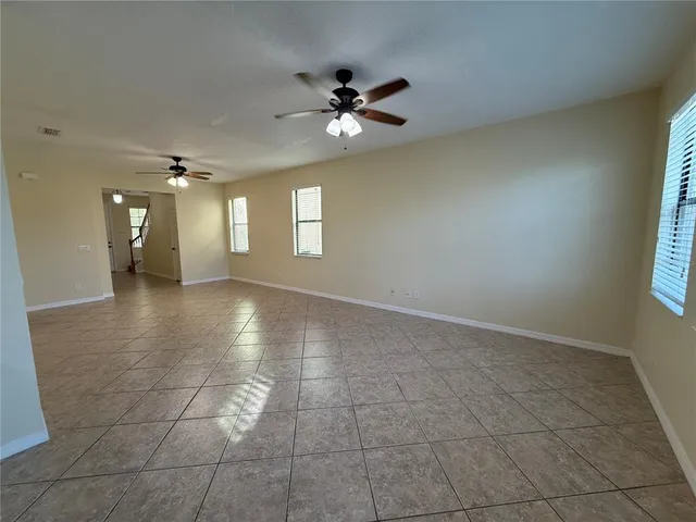 a view of a livingroom with a ceiling fan and window