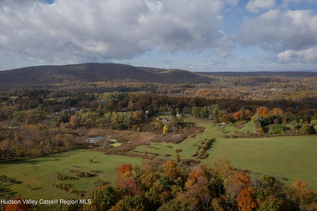an aerial view of house with trees all around