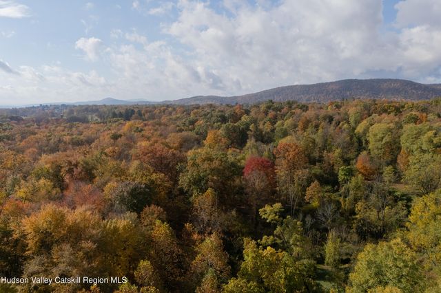an aerial view of town with residential houses and mountain view