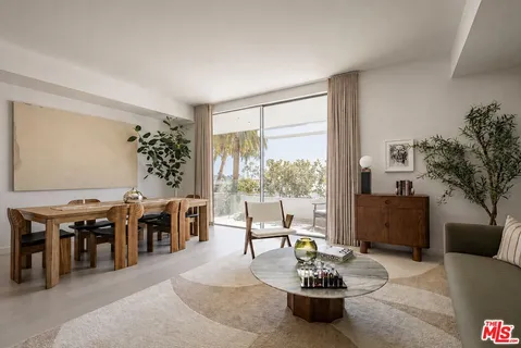 a living room with furniture a dining table and a large window