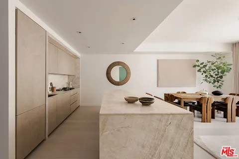 a hallway with a large mirror and a wooden floor
