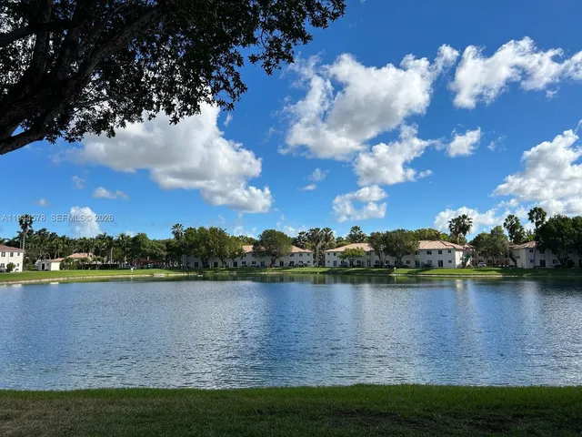 a view of a lake with houses in the background