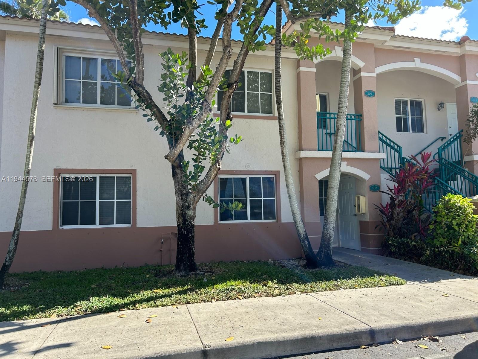 2921 Southeast 12th Road, Unit 10256 Homestead, FL 33035 - Photo 2 of 12 a front view of a house with garden