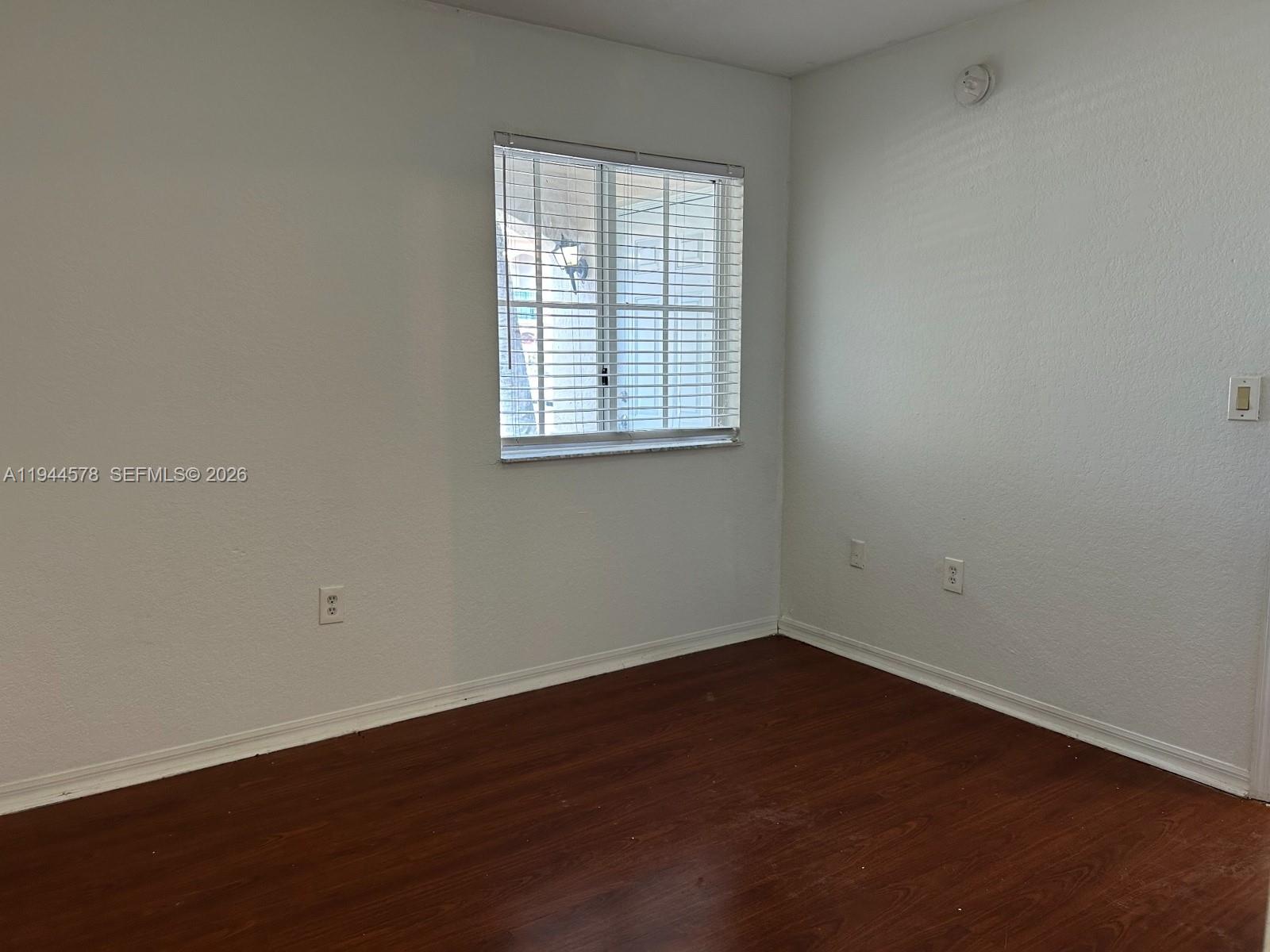 2921 Southeast 12th Road, Unit 10256 Homestead, FL 33035 - Photo 7 of 12 an empty room with wooden floor and windows