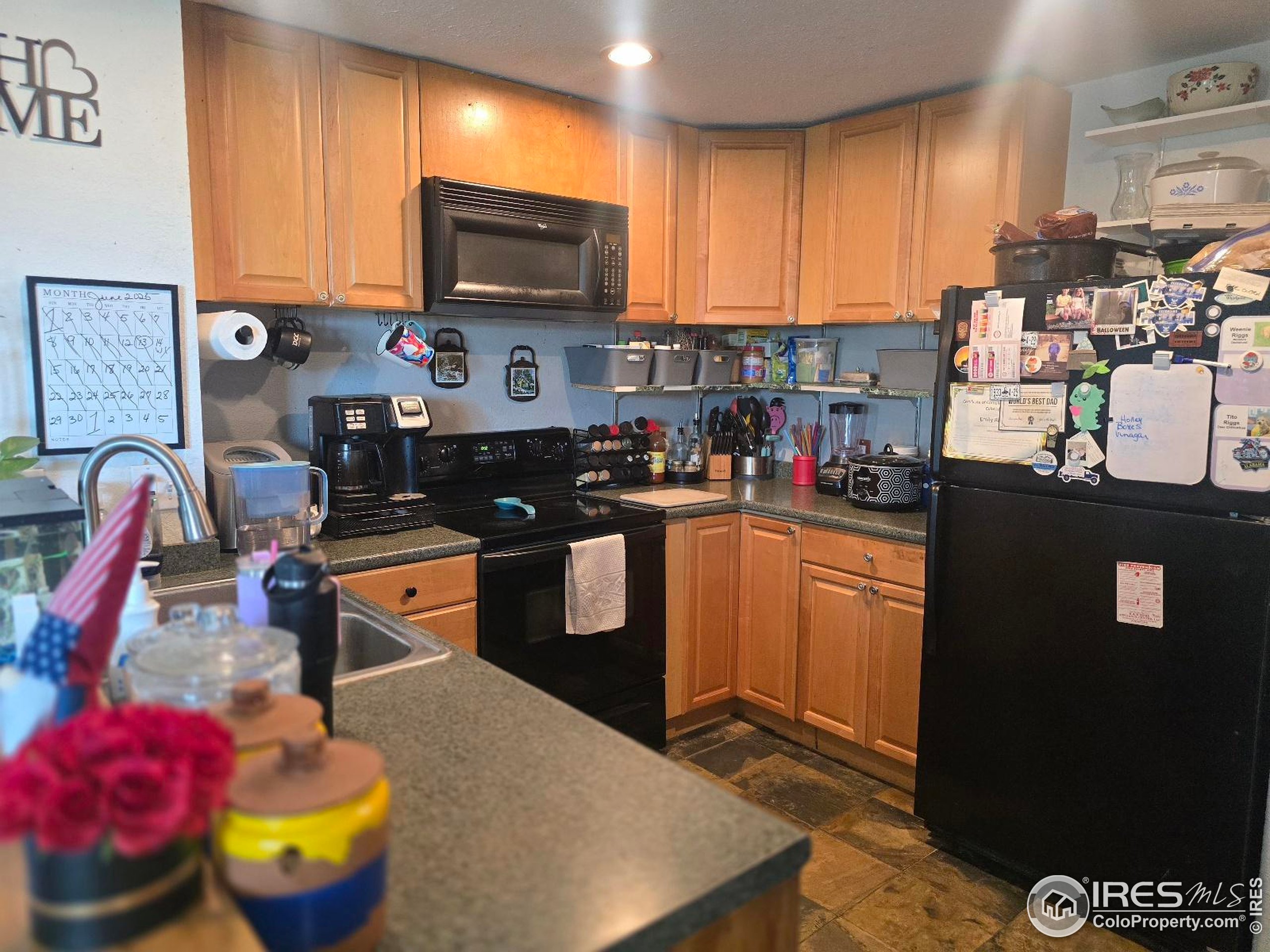 7926 County Road Wiggins, CO 80654 - Photo 11 of 27 a kitchen with stainless steel appliances granite countertop a stove refrigerator sink and cabinets