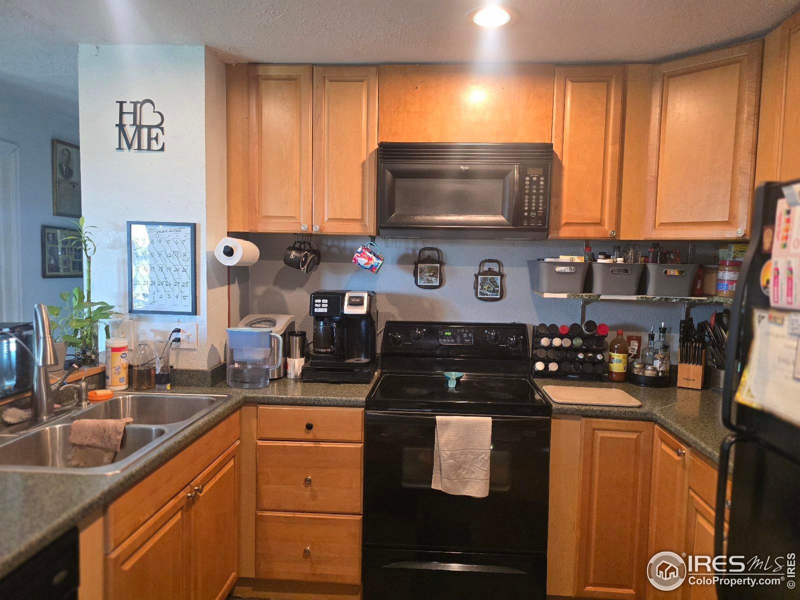 7926 County Road Wiggins, CO 80654 - Photo 12 of 27 a kitchen with a sink stove and microwave