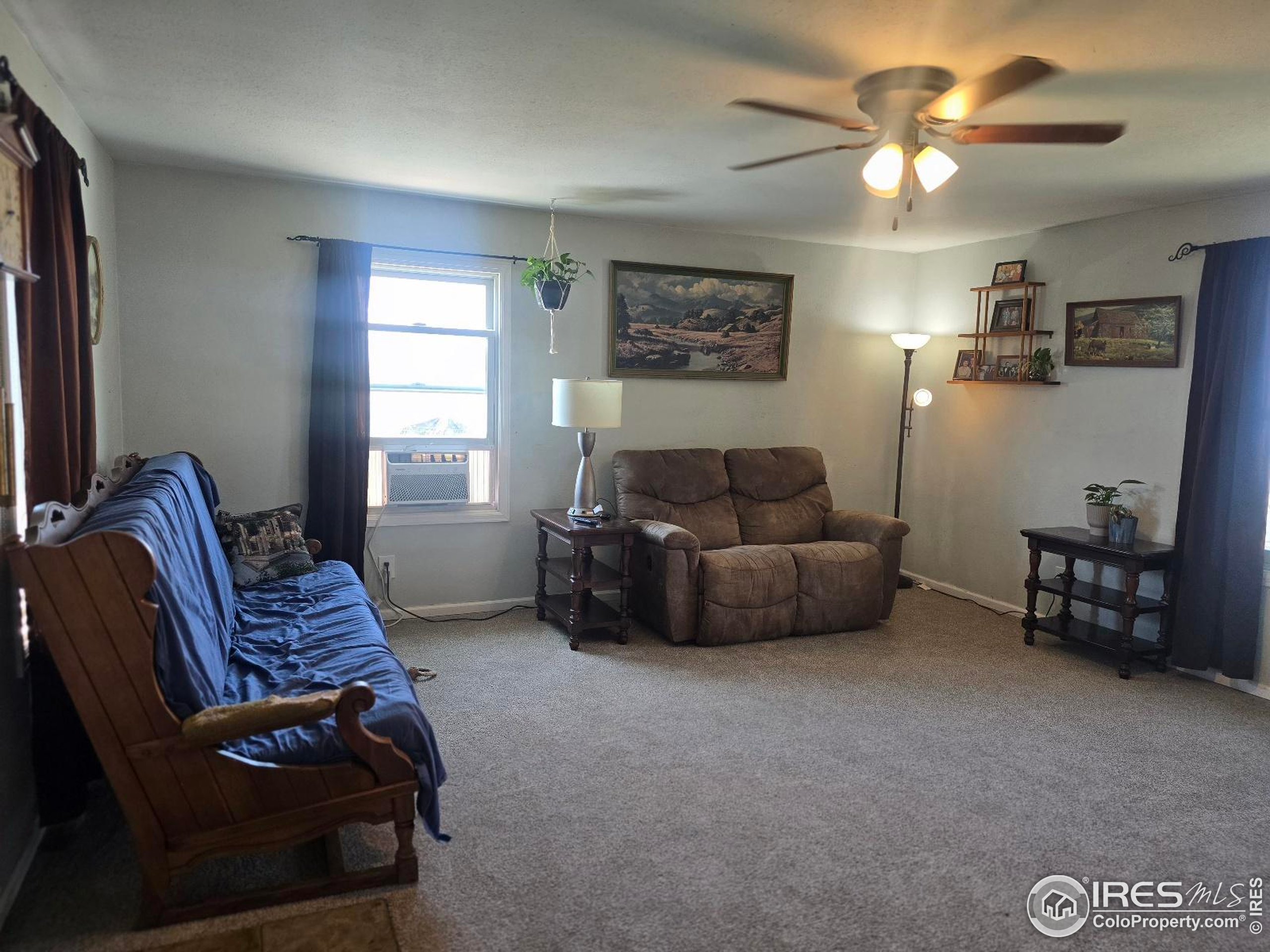 7926 County Road Wiggins, CO 80654 - Photo 13 of 27 a living room with furniture and a window