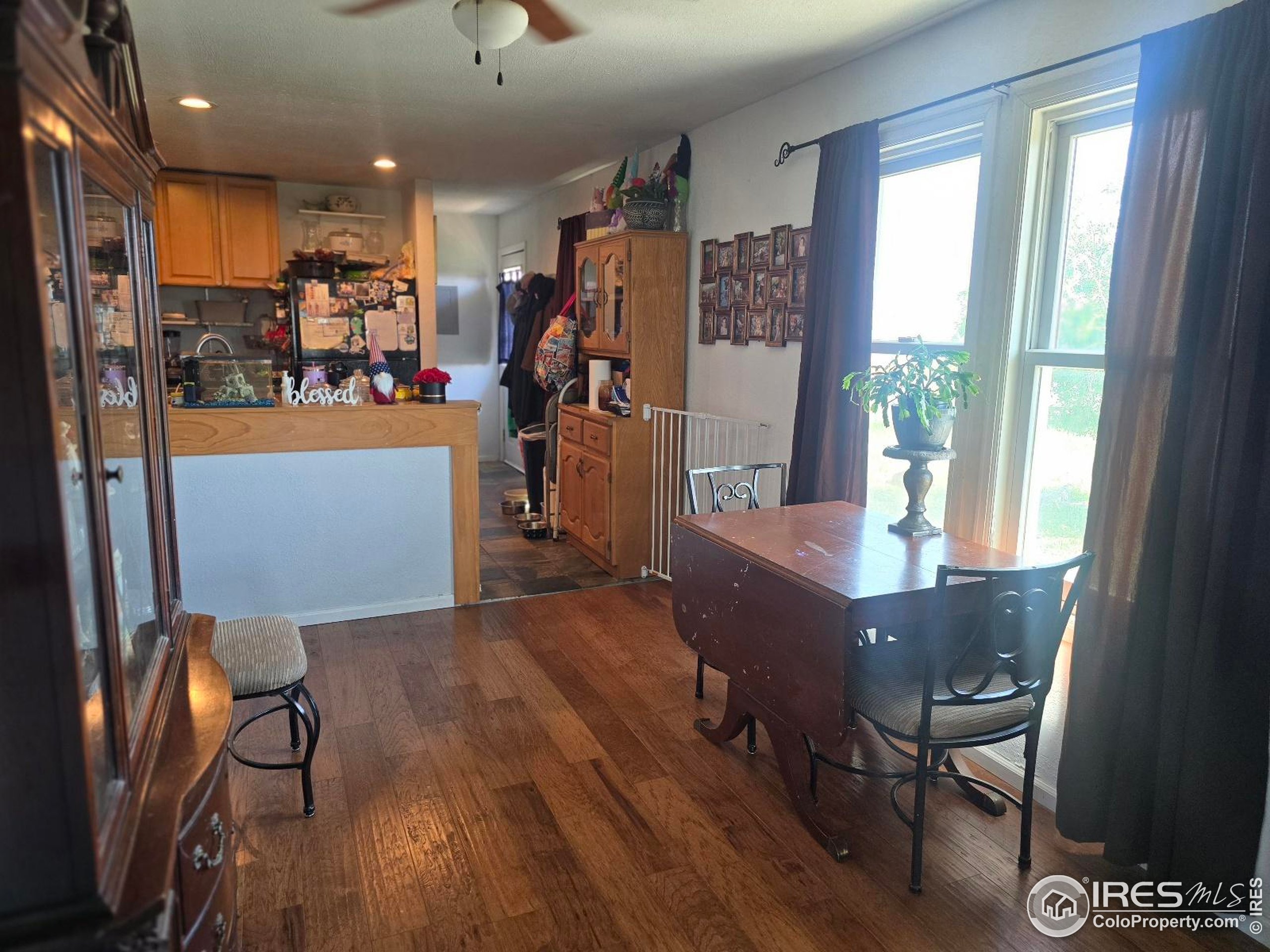 7926 County Road Wiggins, CO 80654 - Photo 17 of 27 a view of a dining room with furniture window and wooden floor