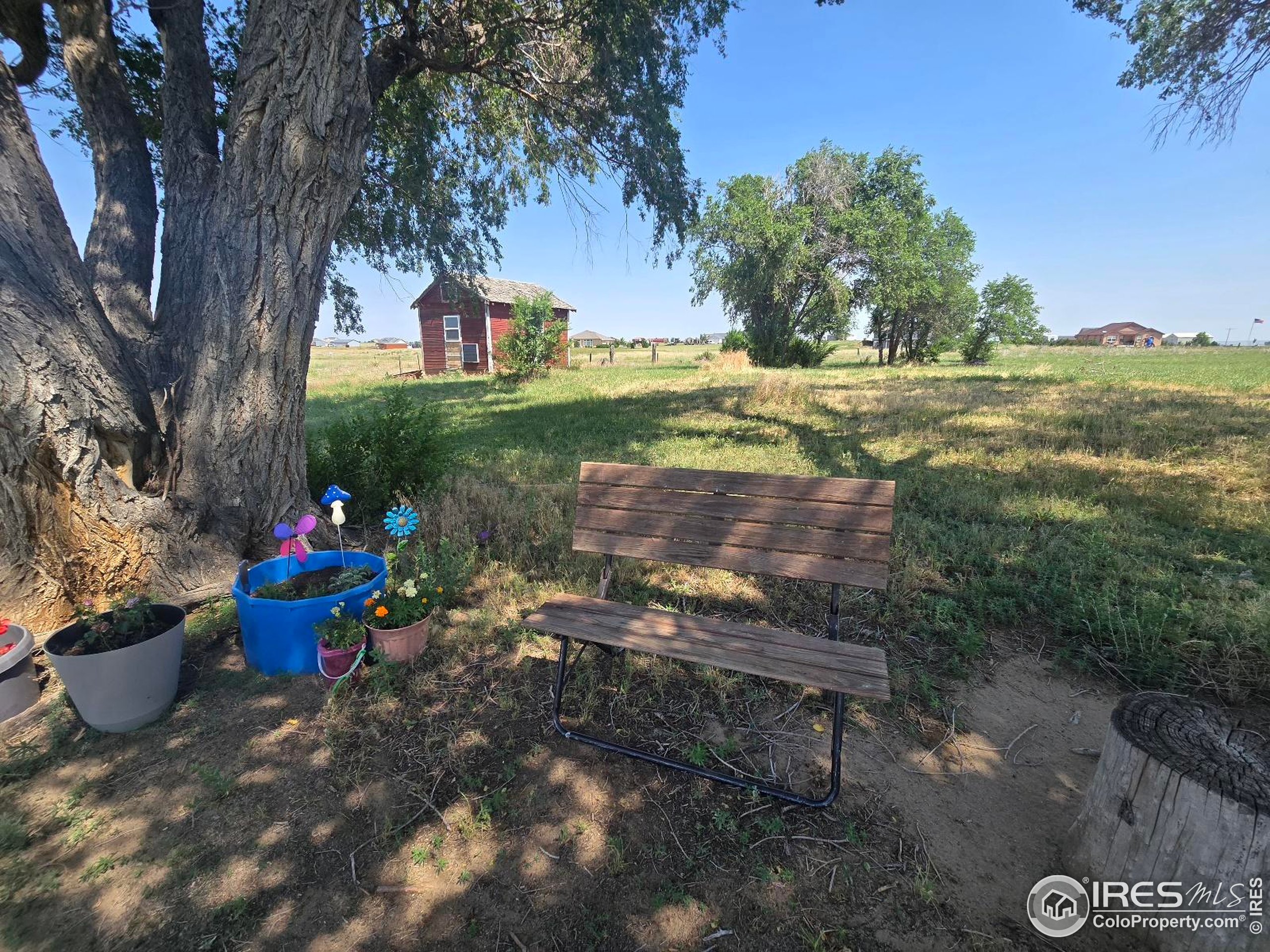 7926 County Road Wiggins, CO 80654 - Photo 2 of 27 a view of a fire pit with a yard