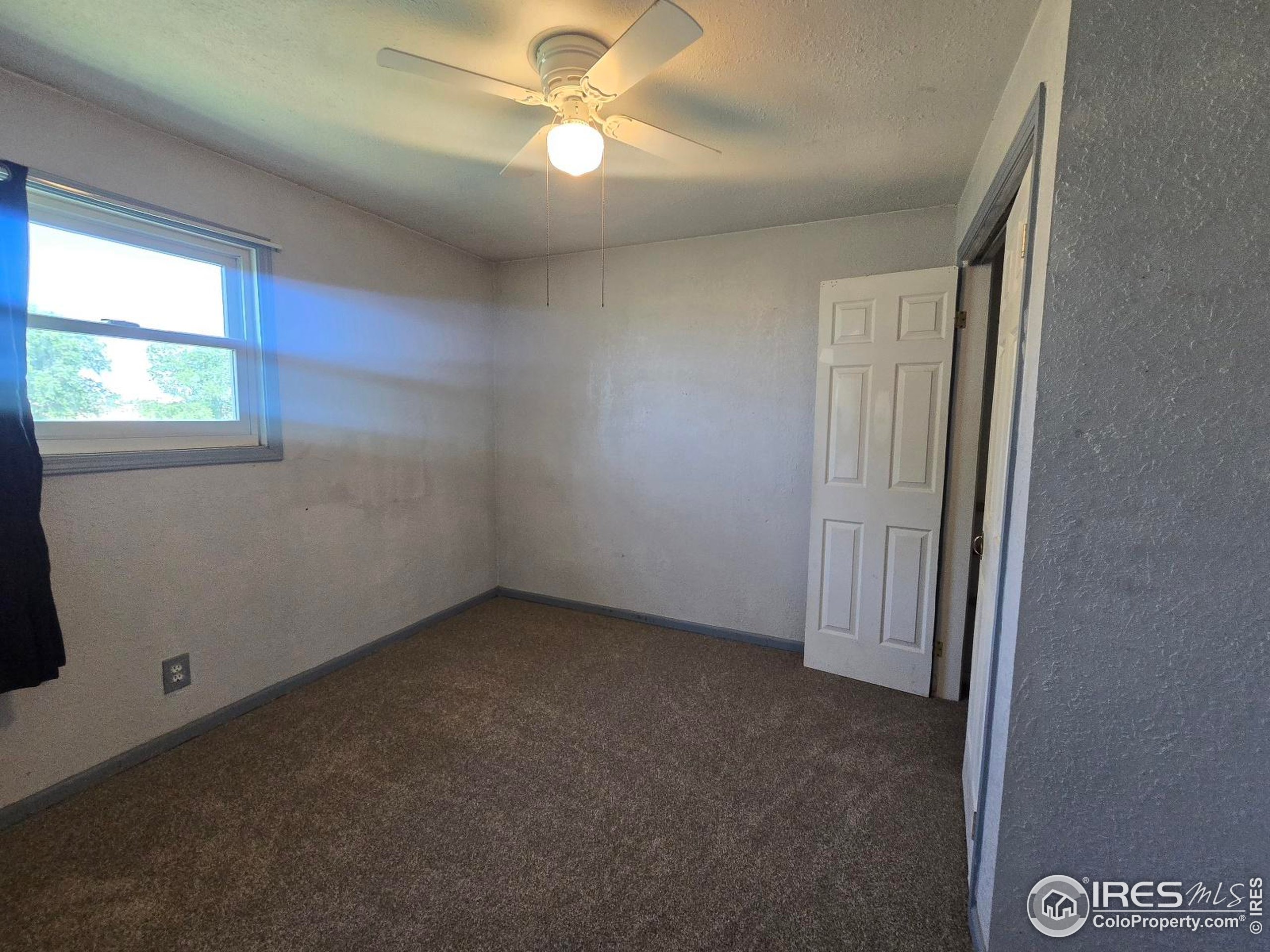7926 County Road Wiggins, CO 80654 - Photo 21 of 27 an empty room with windows and fan