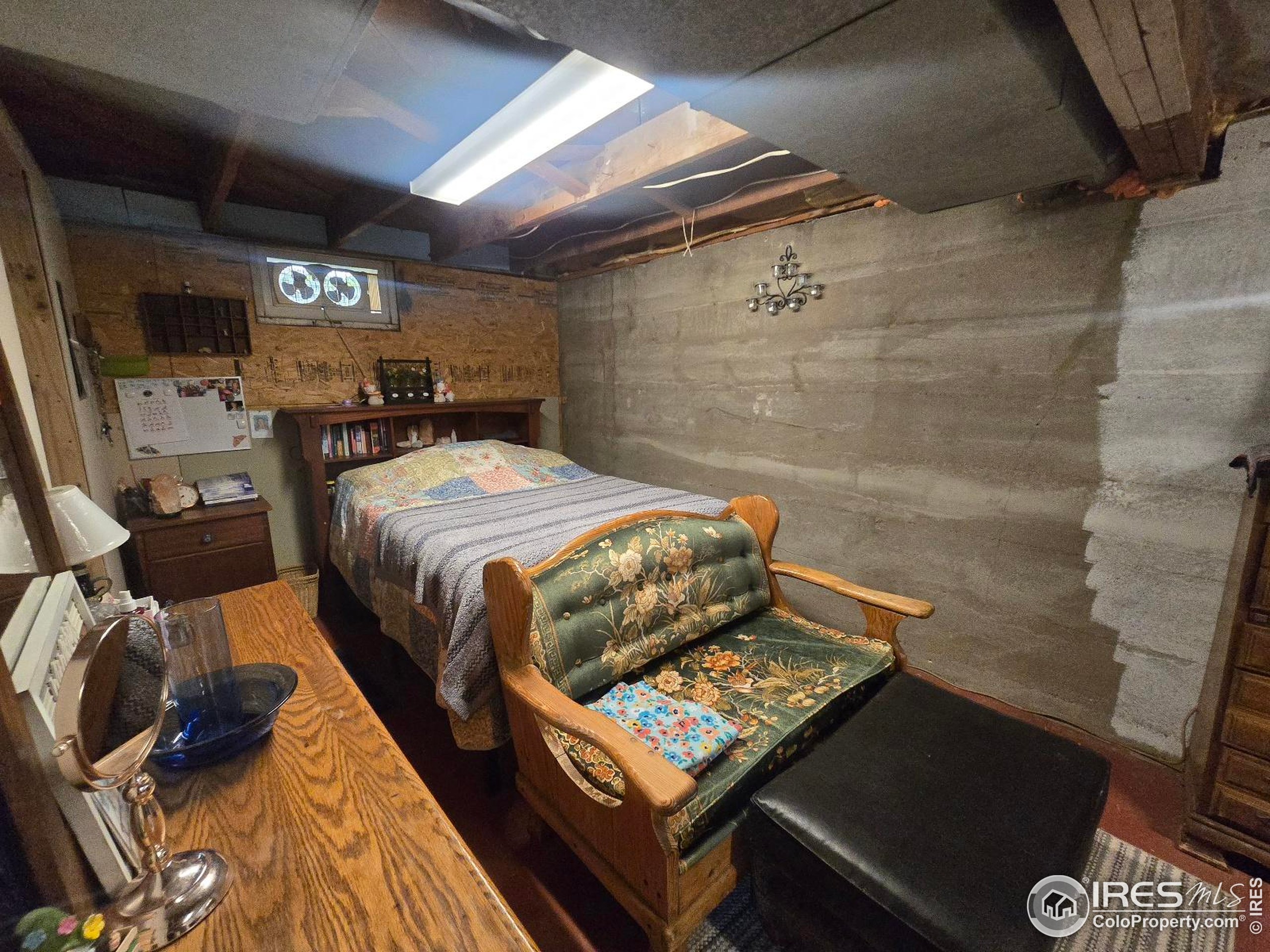 7926 County Road Wiggins, CO 80654 - Photo 27 of 27 a bed sitting in a bedroom next to a tv