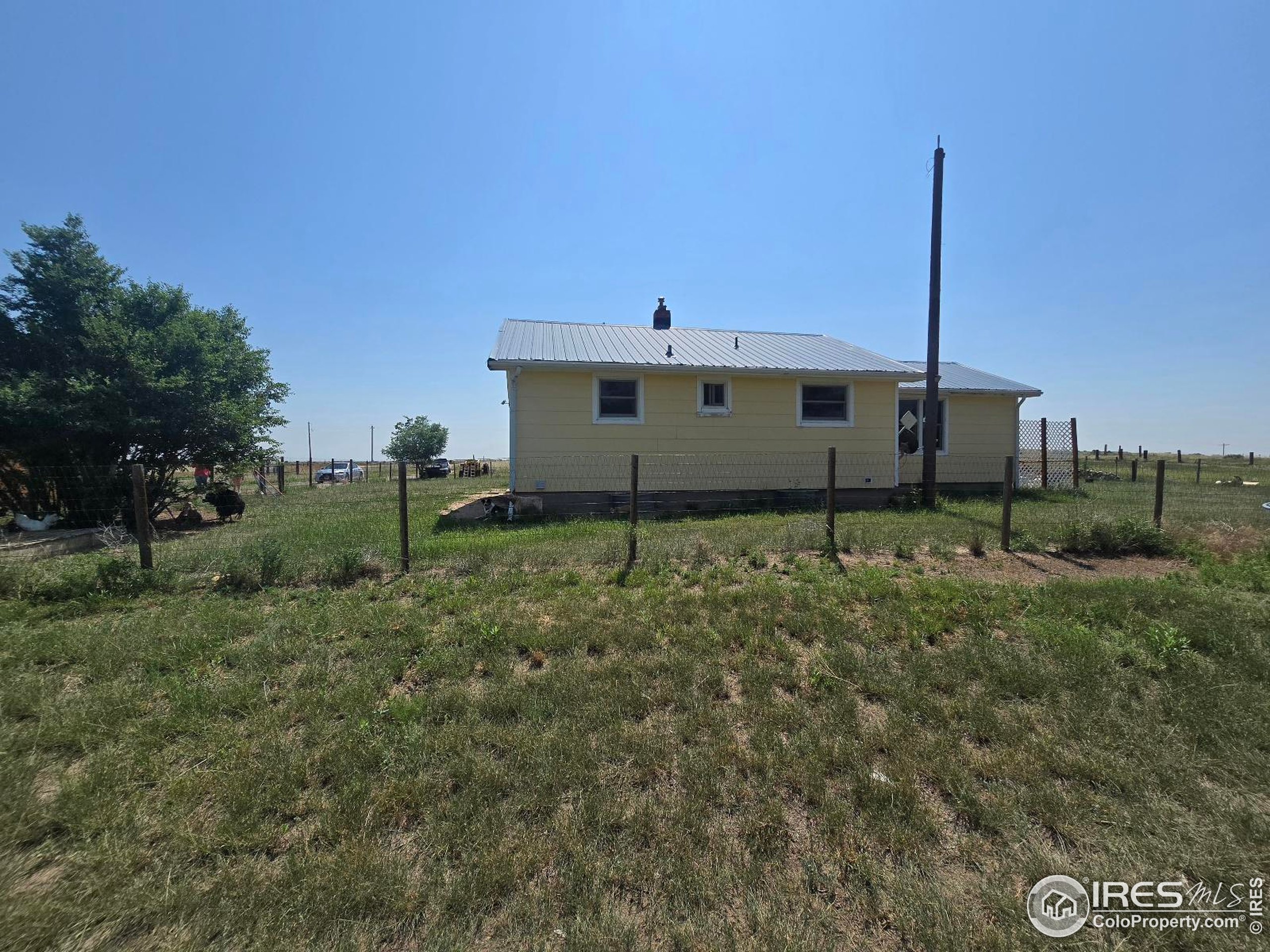 7926 County Road Wiggins, CO 80654 - Photo 10 of 27 a house view with a outdoor space