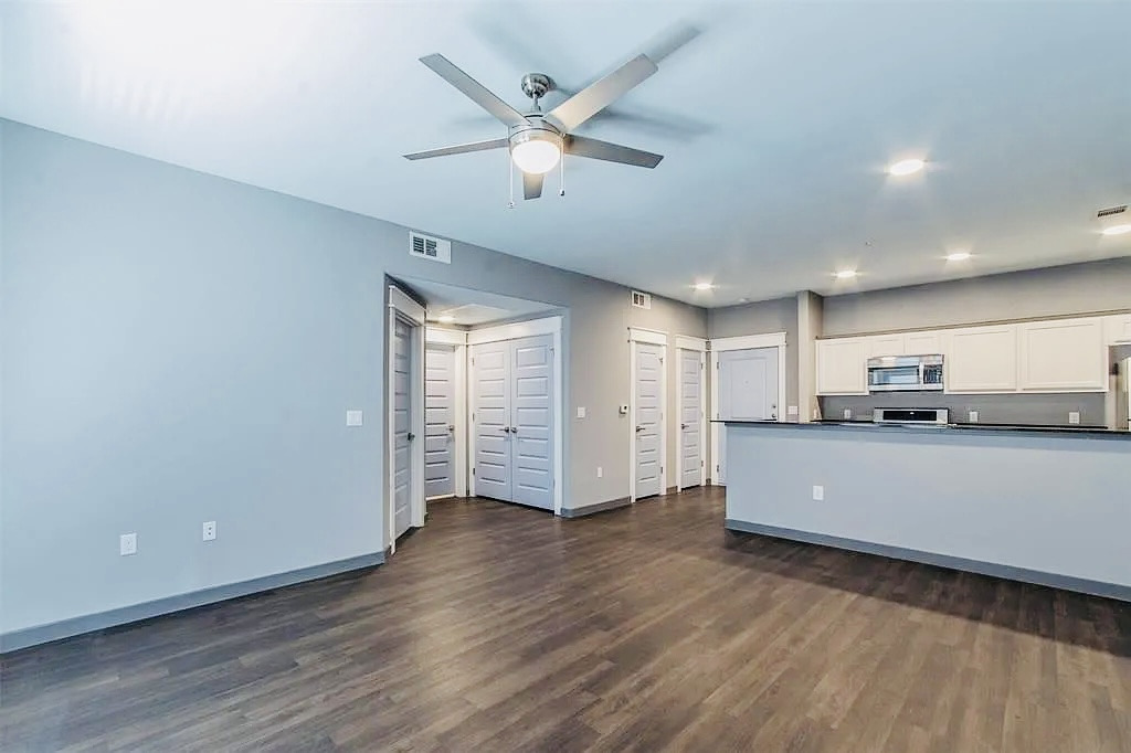 200 Maple Lane, Unit 1302 Elgin, TX 78621 - Photo 11 of 18 a living room with stainless steel appliances kitchen island wooden floors and view living room