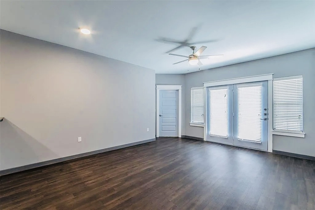 200 Maple Lane, Unit 1302 Elgin, TX 78621 - Photo 14 of 18 an empty room with wooden floor and windows