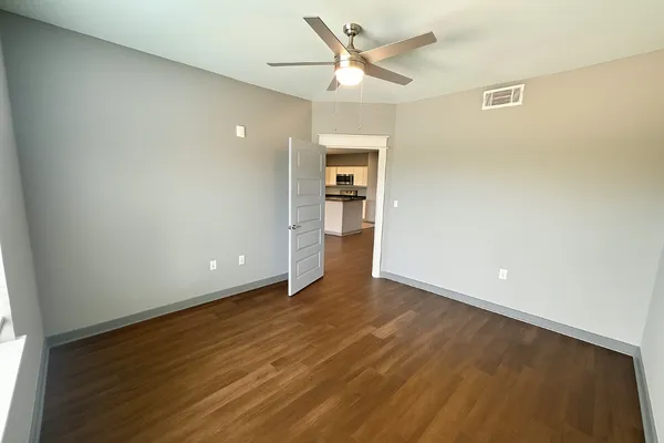 a view of an empty room with wooden floor