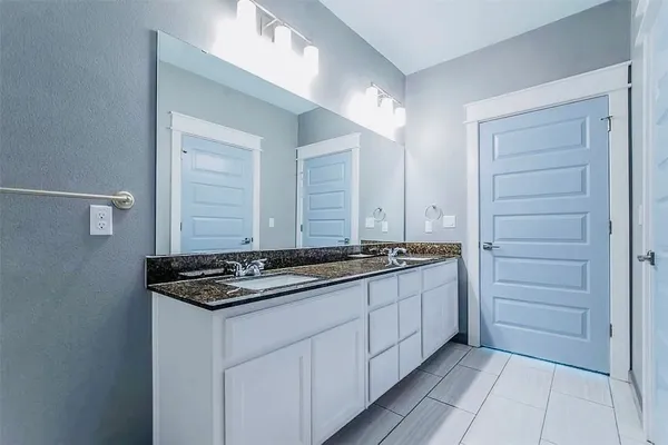 a large kitchen with granite countertop a sink and a stove top oven