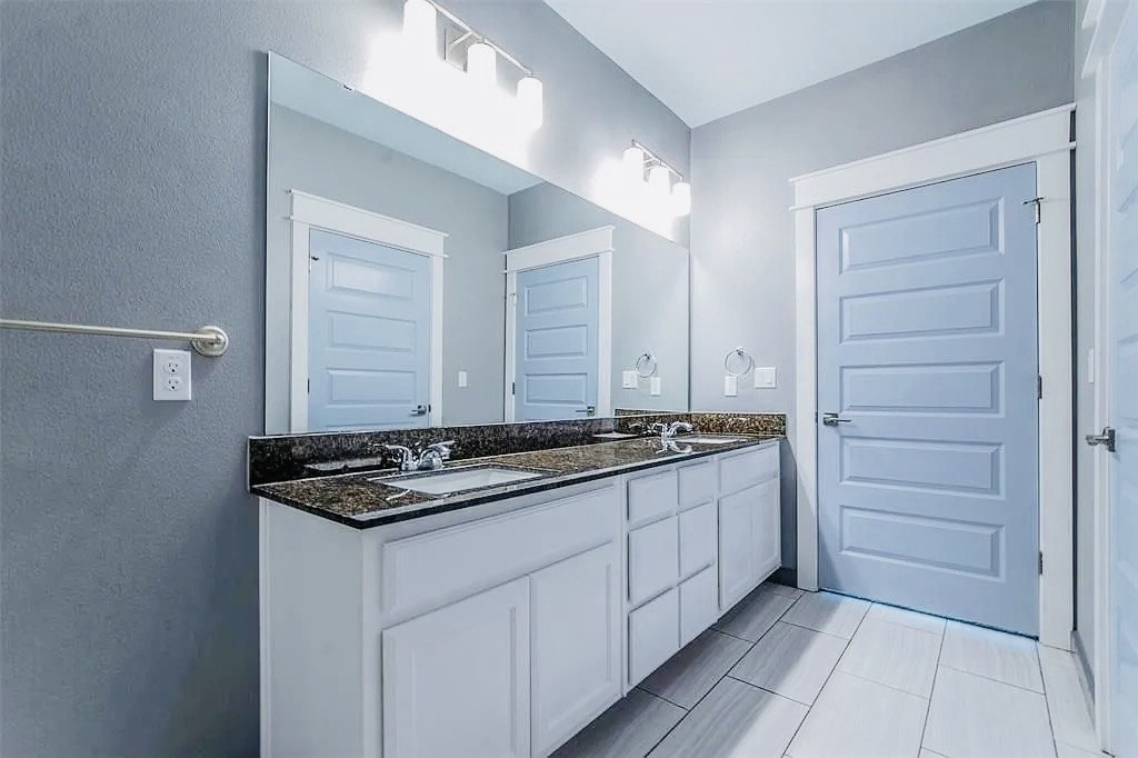 200 Maple Lane, Unit 1302 Elgin, TX 78621 - Photo 7 of 18 a kitchen with stainless steel appliances granite countertop cabinets and a stove top oven