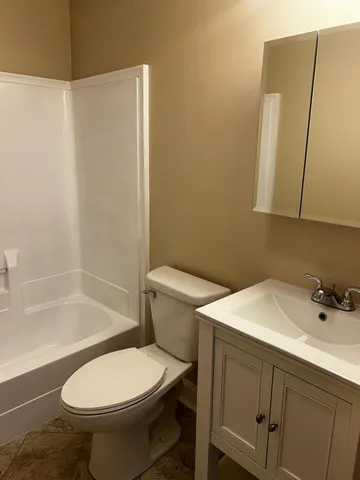 a kitchen with a sink a stove a refrigerator and cabinets