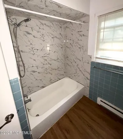 a bathroom with a bathtub and shower
