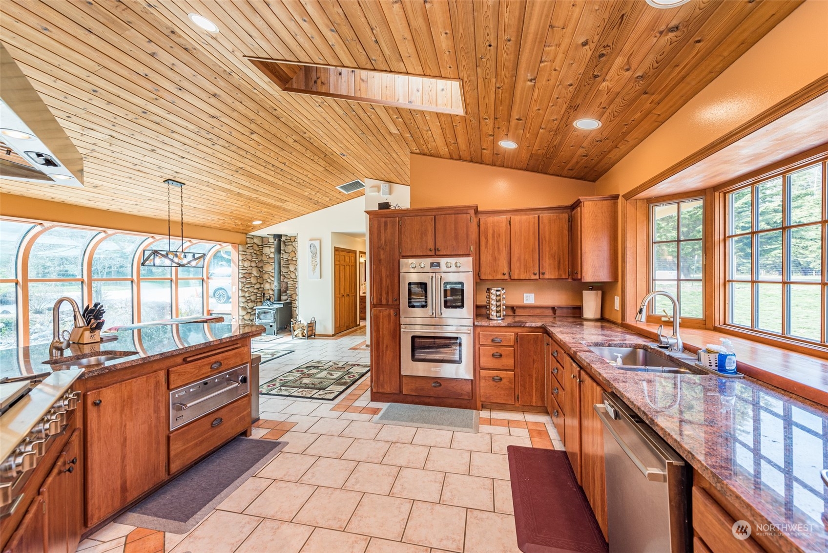 651 Senz Road Sequim, WA 98382 - Photo 7 of 40 a large kitchen with stainless steel appliances kitchen island granite countertop a large stove top oven