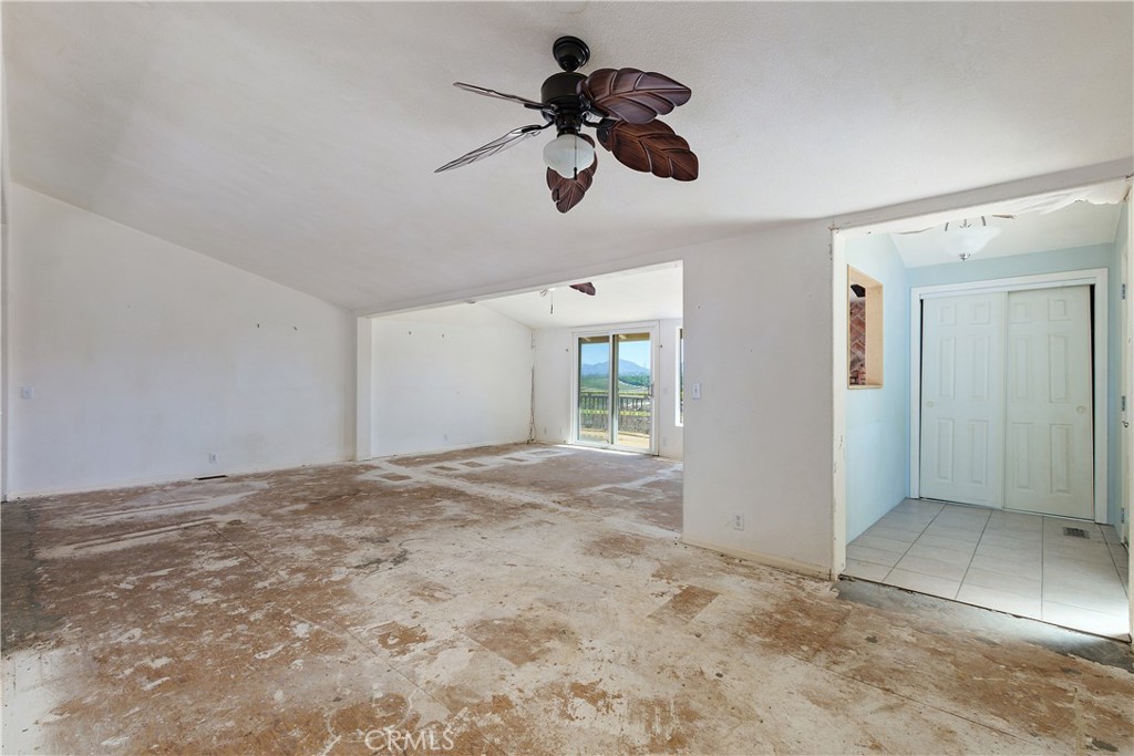 34881 Los Nogales Road Temecula, CA 92592 - Photo 20 of 50 Entry into home with a closet and tile flooring. The oversized great room with 2 ceiling fans. This may also be your dining room/great room combo and the additional area with sliding door to exterior deck.