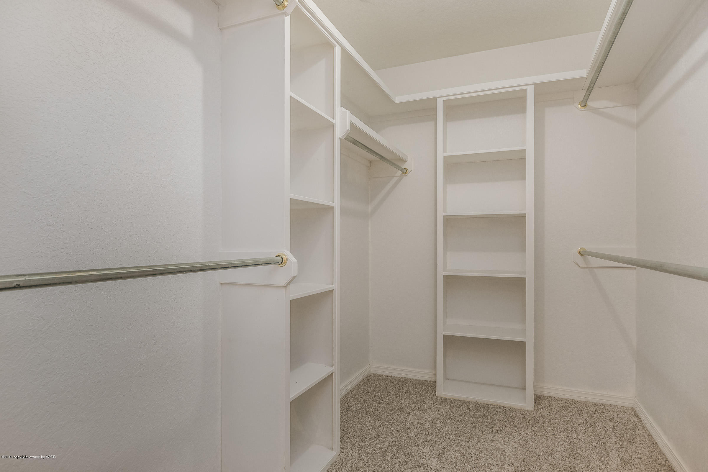 5404 Leo Lane Amarillo, TX 79110 - Photo 14 of 20 a view of walk in closet with empty racks