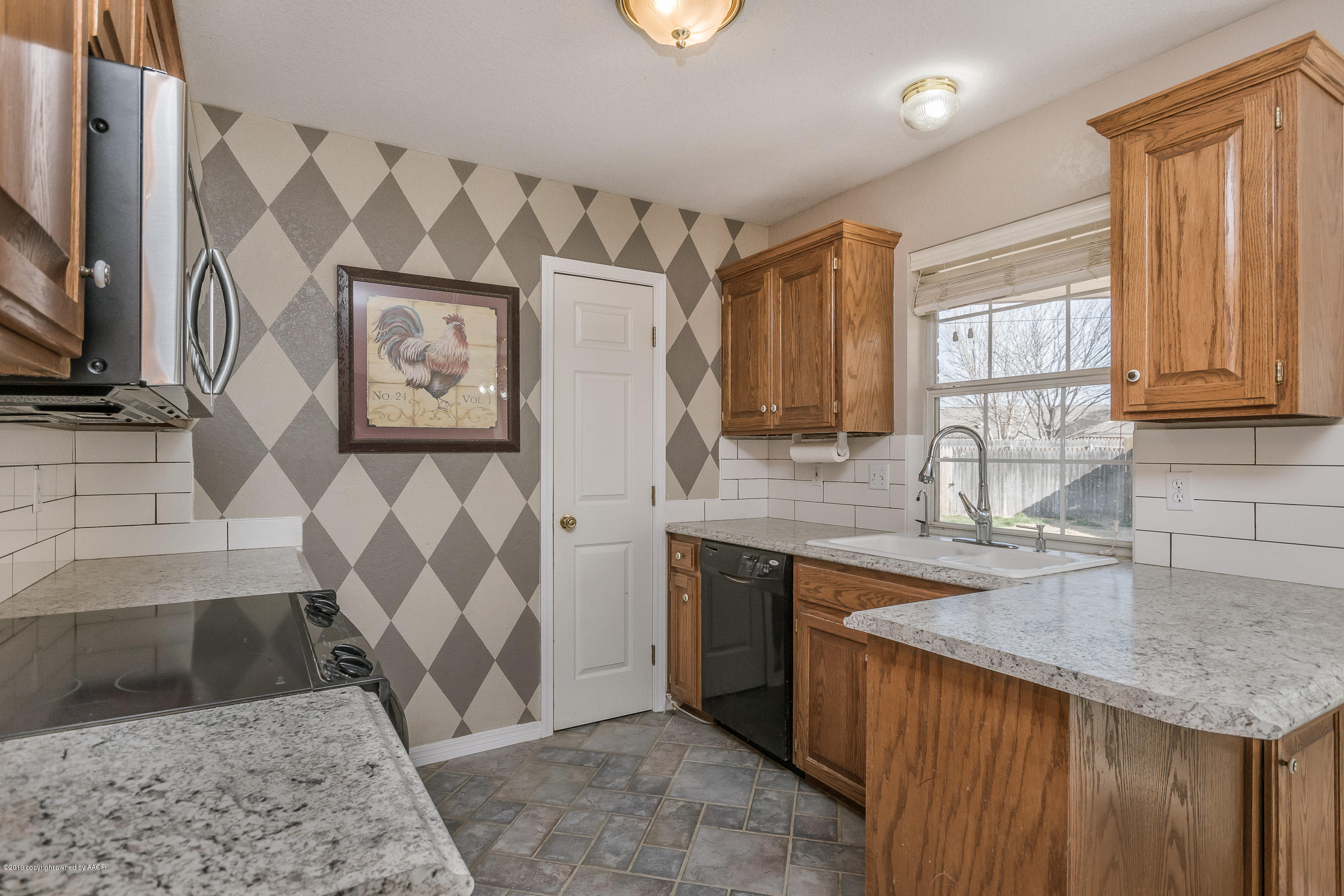 5404 Leo Lane Amarillo, TX 79110 - Photo 6 of 20 a kitchen with stainless steel appliances granite countertop a sink stove and cabinets